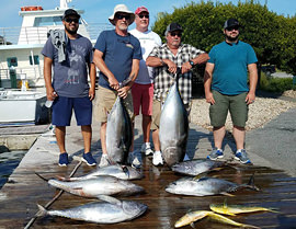 Group with lots of large tuna and mahi mahi caught aboard the Carly A Outer Banks fishing charter.